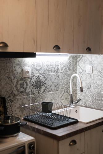 a kitchen counter with a sink and a sink at Sapphire Majesty by Heaven's Hall in Alexandroupoli