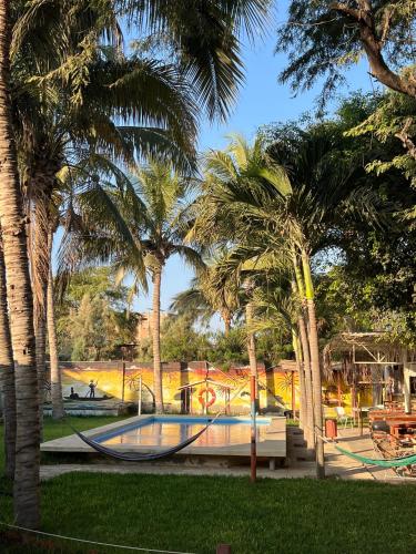 a park with a playground with palm trees at Stone House Mancora in Máncora