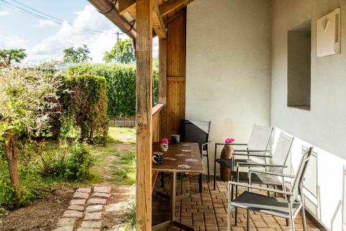 a porch with a table and chairs on a patio at Chaloupka u Kaštánků in Žďárek