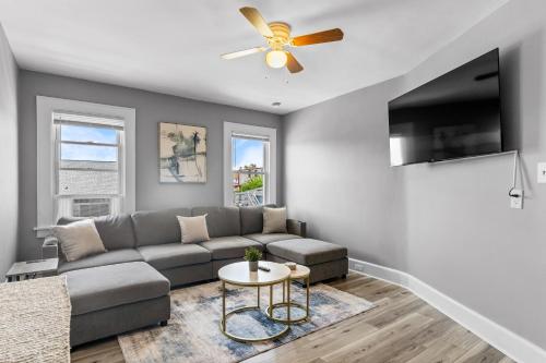 a living room with a couch and a ceiling fan at 2BR Apartment Near Downtown Stamford I Pets OK in Stamford