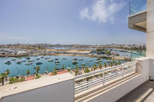 a balcony with a view of a harbor at NEW Duplex penthouse w breathtaking views by SF HOMES in Il-Gżira