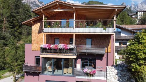 a house with balconies and flowers on it at Haus Valier Tiers in Tires