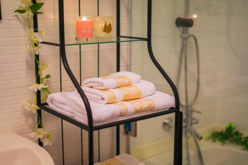 a towel rack with towels on it in a bathroom at Bright Apartment with Sea View, few steps away from the TGV in Tangier