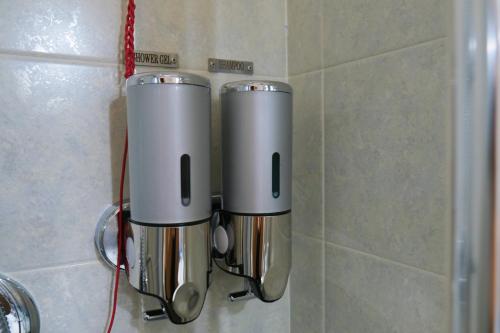 a couple of cups hanging on a wall at Casa Ermes in Santa Maria degli Angeli