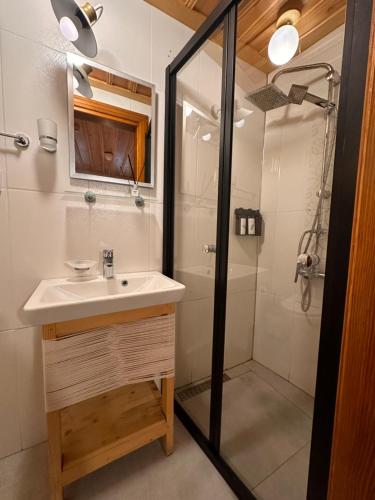 a bathroom with a sink and a shower at Hanole Guest House in Ayvalık