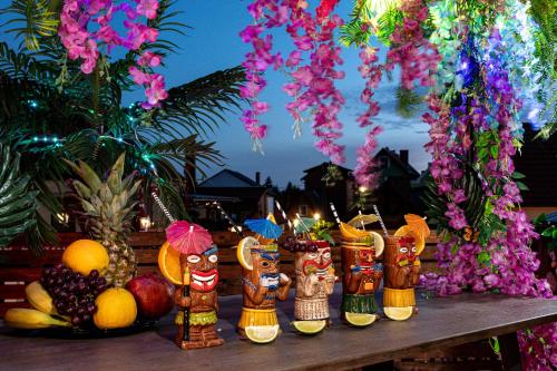 a group of wooden figurines sitting on a table with fruit at Pokoje, Noclegi, Apartamenty Dune Resort Łeba in Łeba