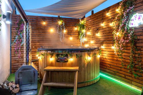 a hot tub in a backyard with lights at Pokoje, Noclegi, Apartamenty Dune Resort Łeba in Łeba