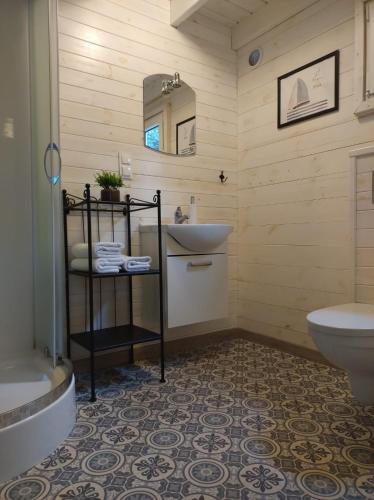 a bathroom with a sink and a toilet at Siesta Camp Łeba in Nowęcin