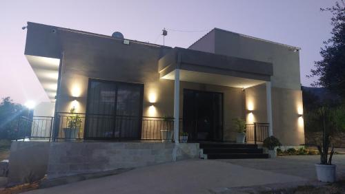 a white house with a staircase in front of it at Mezzanine Bay in Himare