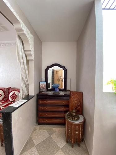 a bedroom with a dresser and a mirror at Dar Wafae in Rabat