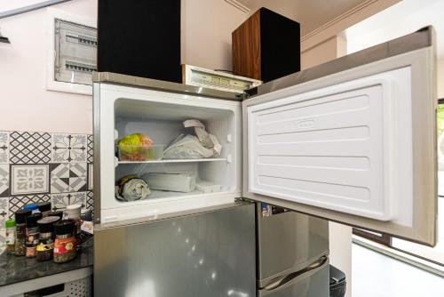 a refrigerator with its door open in a kitchen at iVAVev IS US ByTheSea EforieSud in Eforie Sud