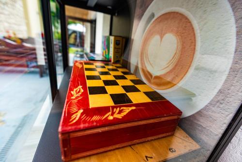 a chessboard and a roll of paper in a store window at iVAVev IS US ByTheSea EforieSud in Eforie Sud