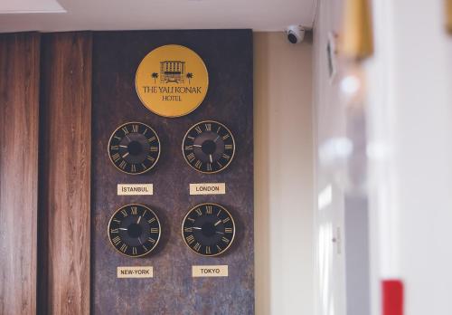 a group of clocks on a wall in a room at The Yalı Konak Hotel İzmir in Izmir