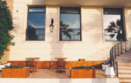 a patio with chairs and tables on a house at The Yalı Konak Hotel İzmir in Izmir