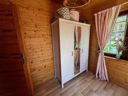 a room with a door and windows in a wooden house at Lavender Cottage in Sucha Rzeczka