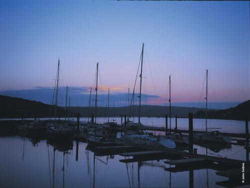 a group of boats docked in a marina at sunset at Trident Hotel Kinsale in Kinsale