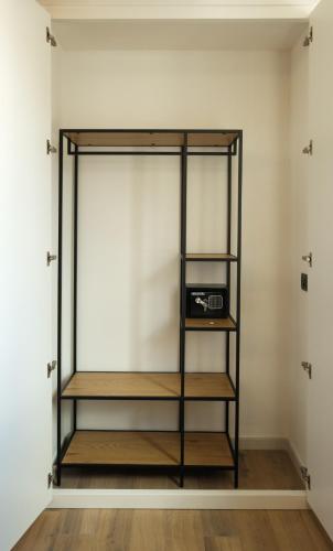 a book shelf in a room with a window at Mazzini House B&B in Sassari