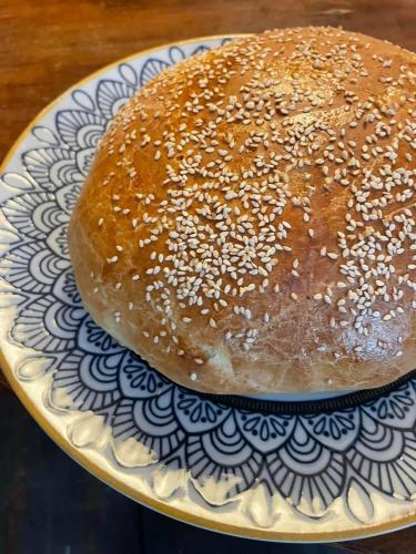 a bagel sitting on a plate on a table at Art Gallery Dyk in Chvalšiny