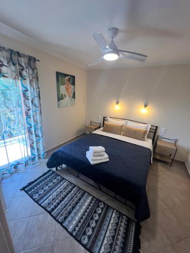 A bed or beds in a room at Queen of Orliaka