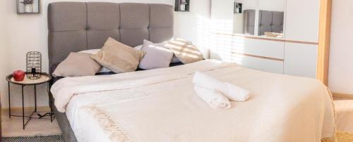 a bedroom with a large bed with white sheets and pillows at Apartman Lili in Knin