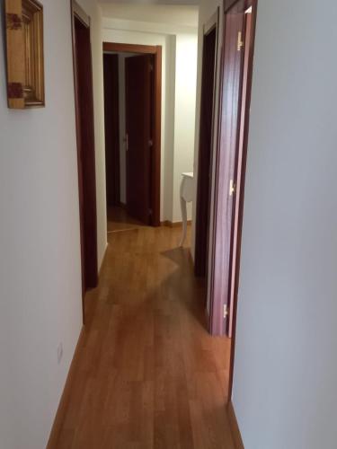 a hallway with a door open to a room at Piso DJC in O Pedrouzo