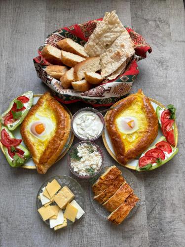 a table with plates of food and a basket of bread at Mark in Yeghegnadzor