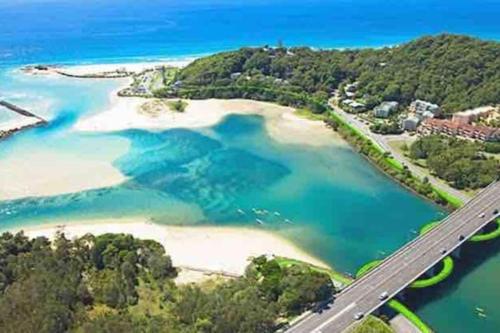 an aerial view of a beach with a bridge at Acreage near Currumbin Beach in Currumbin Valley