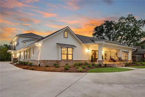 a white house with a sunset at The Ascension by Kyle in College Station