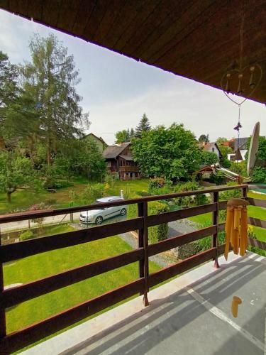 a view from the porch of a house with a car on a fence at Randy's House Plzeň in Plzeň