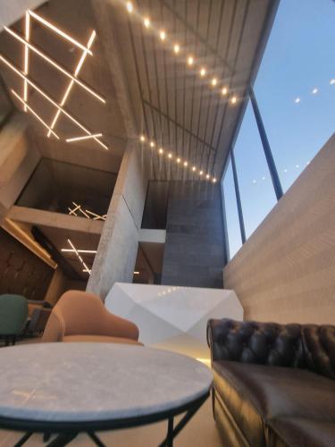 a living room with a table and a couch at 365 UrbanLiving in Jbeil