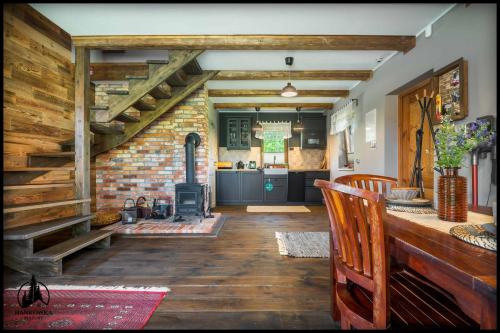 a living room with a staircase and a kitchen at Hankówka Mazury in Jerutki