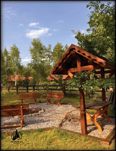 a group of wooden benches in a park at Hankówka Mazury in Jerutki
