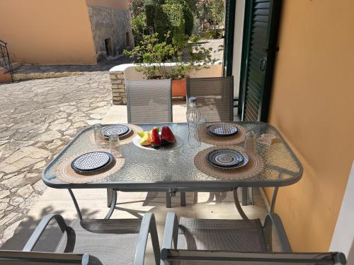 a table with a plate of fruit on it at 9 Muses Villas in Chrani