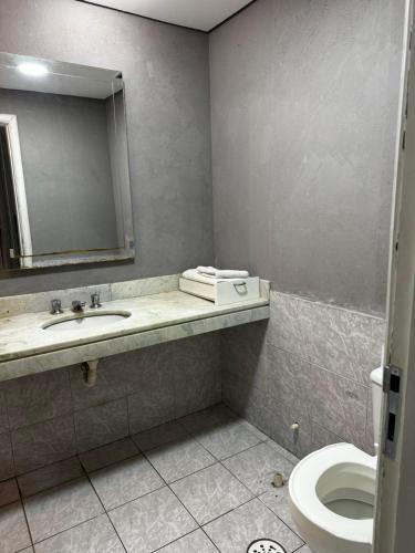 a bathroom with a sink and a toilet at Flat no coração de Alphaville in Barueri