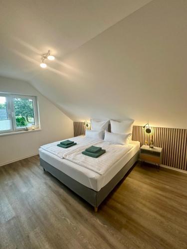 a bedroom with a bed with white sheets and a window at Familie oder beruflich - 2 Schlafzimmer - 3 Betten - Geräumig - Küche - Gemütlich in Bad Lippspringe
