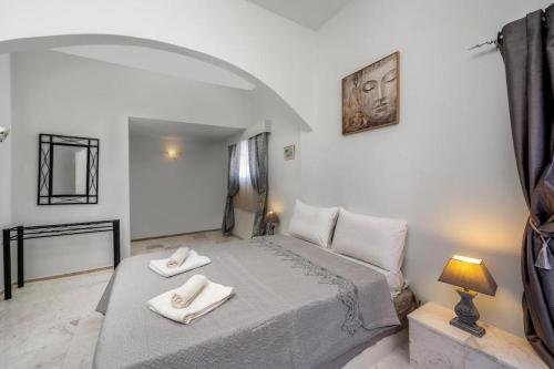 a bedroom with a bed with two towels on it at Exquisite Retreat For Two in Archangelos