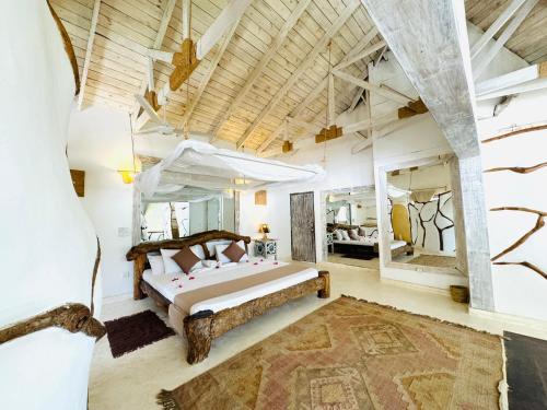 a bedroom with a large bed in a room at Dream Luxury B&b Watamu in Watamu