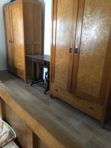 a room with a desk and wooden cabinets at Cica Vintage Eco House Near Lake in Crkvine