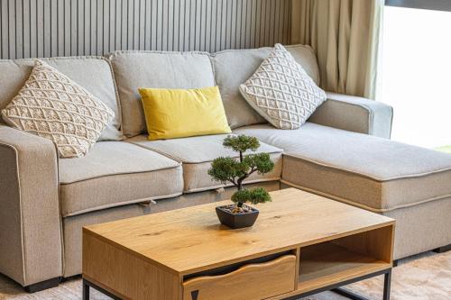 a living room with a couch and a coffee table at 1BR Skyview Penthouse by Blue Cloud Holidays in Sharjah