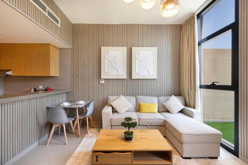 a living room with a couch and a table at 1BR Skyview Penthouse by Blue Cloud Holidays in Sharjah