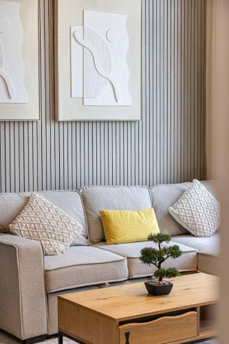 a living room with a couch and a coffee table at 1BR Skyview Penthouse by Blue Cloud Holidays in Sharjah