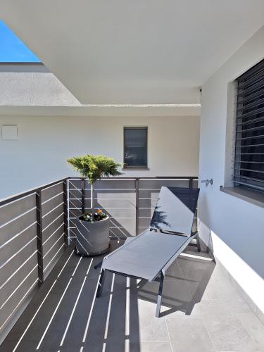 a balcony with a chair and a television on it at T-Collection Premium Apartments in Vipiteno