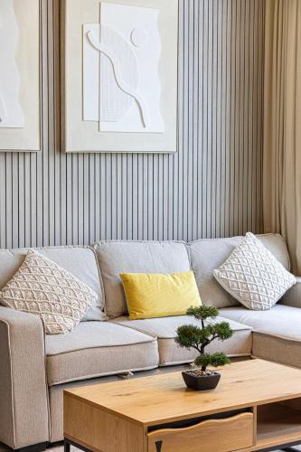 a living room with a couch and a coffee table at 1BR Skyview Penthouse by Blue Cloud Holidays in Sharjah