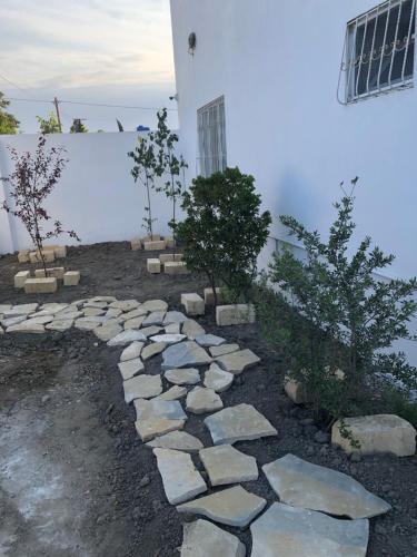 a stone walkway in front of a white building at Muhtadir in Xudat