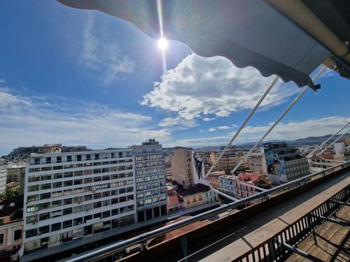 a view of a city with the sun in the sky at SleepEasy in Athens