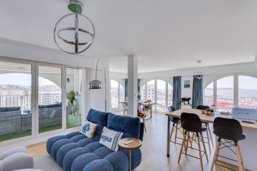un salon avec un canapé bleu et une table dans l'établissement Luxe, vue mer et parking privé, à Marseille