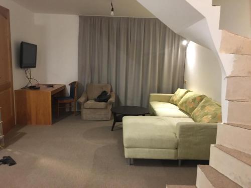 a living room with a couch and a table at Na Zvonici in Paseky nad Jizerou