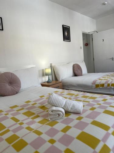 a bedroom with two beds and a blanket on the floor at Lovely Rooms in Camden Town-Central London in London