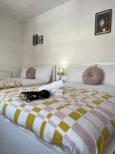 a large bed with a striped blanket on it at Lovely Rooms in Camden Town-Central London in London
