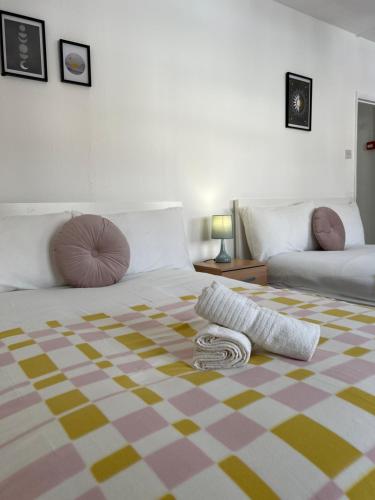 a bedroom with a bed with a blanket on the floor at Lovely Rooms in Camden Town-Central London in London